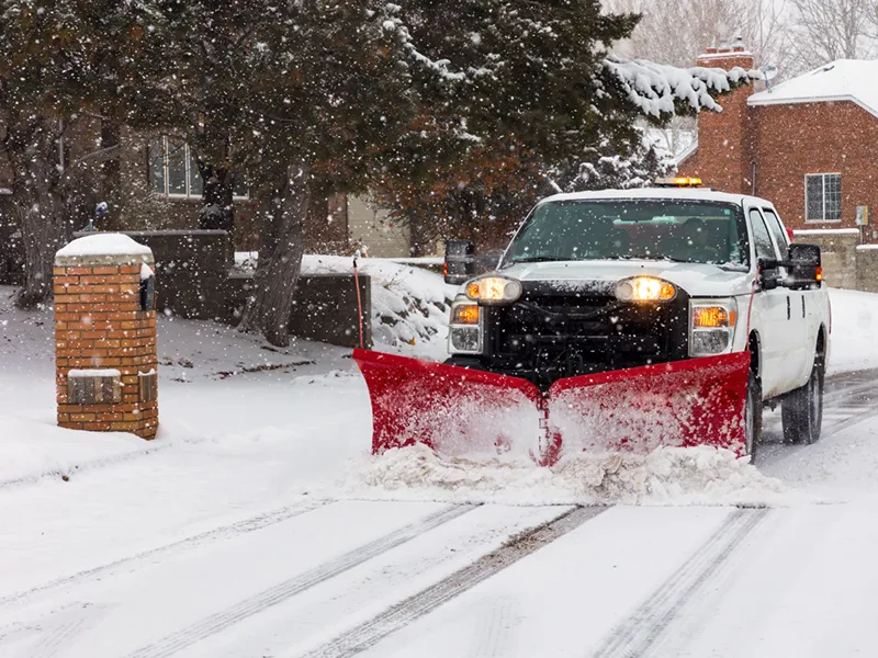 Snow plow clearing the neighborhood roads